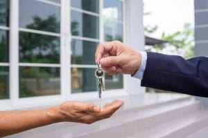 A person's handing over keys to rent out their property.